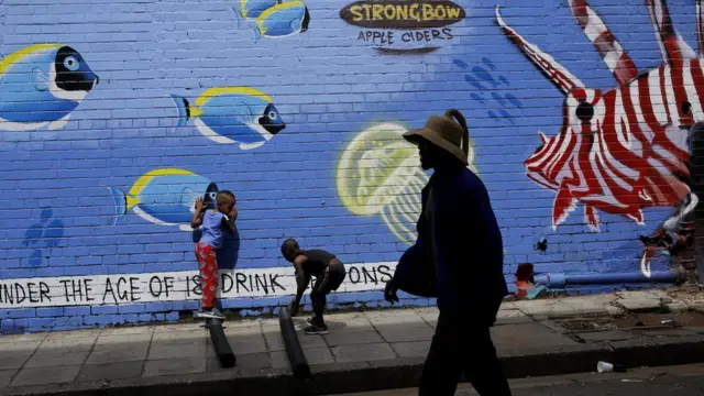 A man walks past a new piece of graffiti art painted on a wall in downtown Johannesburg, South Africa, 07 December 2017. The art work, which depicts an underwater world with fish and a turtle, is in the Maboneng area of the biggest city in the country.