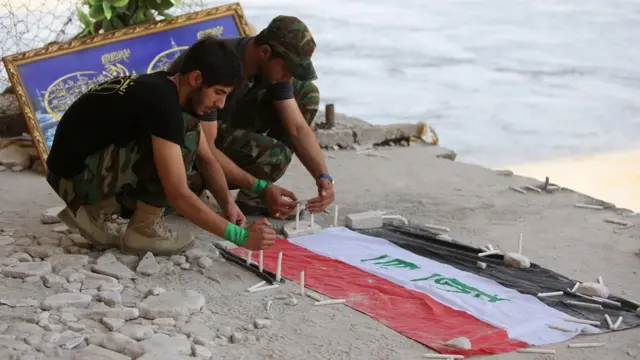 A commemoration service near the river Tigris for soldiers killed in Camp Speicher in 2014 by IS militants.