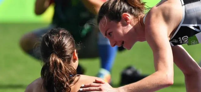 Abbey D"Agostino (L) of the USA is helped up by Nikki Hamblin (R) of New Zealand after both fell during the women"s 5000m heats of the Rio 2016 Olympic Games Athletics, Track and Field events at the Olympic Stadium