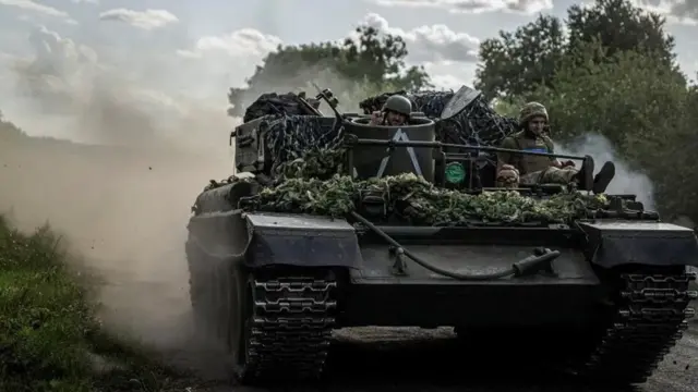 Soldiers on a tank in the frontline