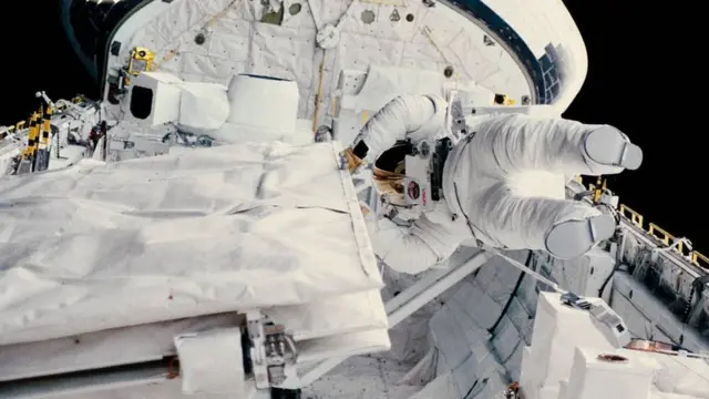 Astronaut Kathryn D. Sullivan checks the latch of the SIR-B antenna in the space shuttle Challenger's open cargo bay during her historic extravehicular activity (EVA) on Oct. 11, 1984