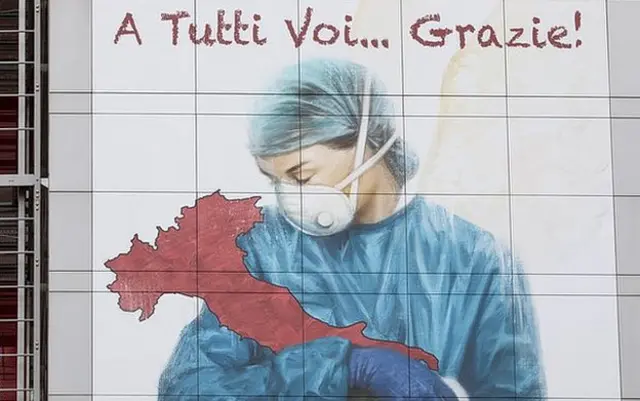 A mural dedicated to Italian medical workers depicts a nurse cradling Italy and reads: 'To All Of You... Thank You!', on a wall of Papa Giovanni XXIII Hospital on March 25, 2020 in Bergamo