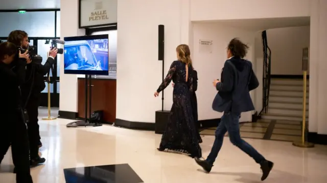 Actress AdÃ¨le Haenel leaves the Salle Pleyel after the award for best director was given to Roman Polanski