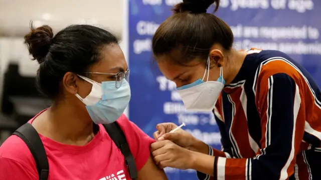 A woman receives a dose of COVISHIELD, a coronavirus disease (COVID-19) vaccine manufactured by Serum Institute of India, at a vaccination centre in Ahmedabad, India, May 1, 2021