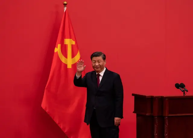 General Secretary and Chinese President, Xi Jinping waves as he leaves after speaking at a press event with members of the new Standing Committee of the Political Bureau of the Communist Party of China and Chinese and Foreign journalists at The Great Hall of People on October 23, 2022 in Beijing, China.