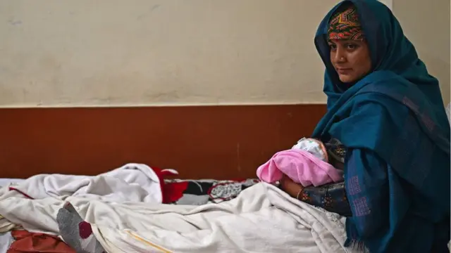 A woman breastfeeds her newborn child inside a maternity ward of a civil hospital in Dehra, in Kangra district of India's Himachal Pradesh state.