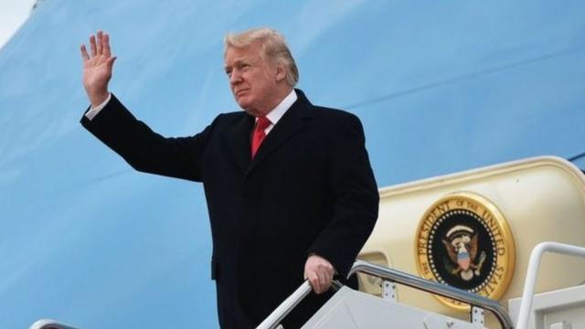 President Donald Trump waves from plane
