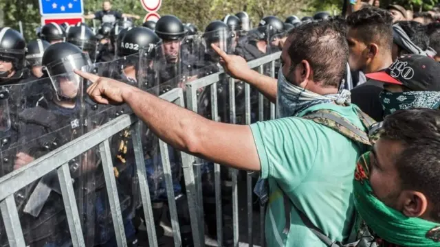Refugees protest at the border station between Serbia and Hungary near Horgos, northern Serbia, 16 September 2015