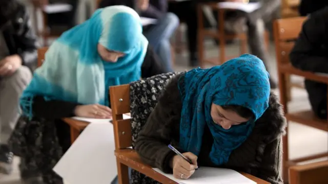 صورة امرأتين في معهد دراسي تكتبان