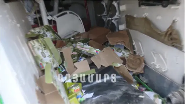 A grab taken from a handout video released by the so-called Nagorno-Karabakh (NKR) Defense Army, or Artsakh Defence Army, via Youtube claims to show Azerbaijani food rations in a tank allegedly destroyed in shelling, artillery and air attacks along the front at Nagorno-Karabakh Republic, on a border of Armenia and Azerbaijan, 27 September 2020