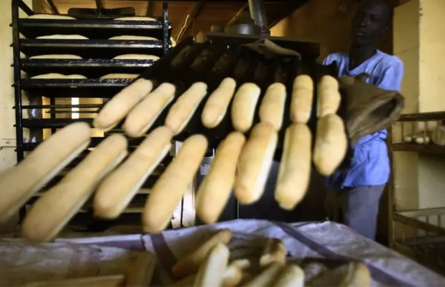A Sudanese man works at a bakery in the capital Khartoum on January 5, 2018. Angry Sudanese queued outside bakeries in Khartoum as bread prices doubled overnight, with bakers blaming a government decision to stop importing wheat. Men, women and children had to wait for nearly an hour to to buy bread, while several bakery operators said price hikes on flour meant they would be forced to stop production entirely.