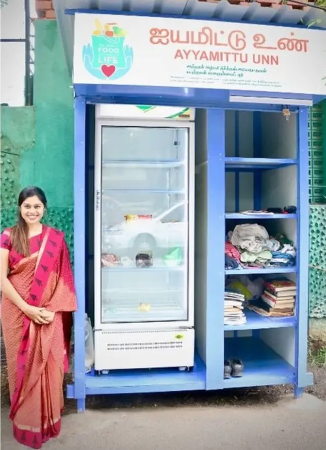 ફ્રિજ સાથે ઊભી રહેલી મહિલા