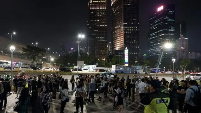 People gather outside an office building following an earthquake hit in Jakarta, Indonesia, August 2, 2019