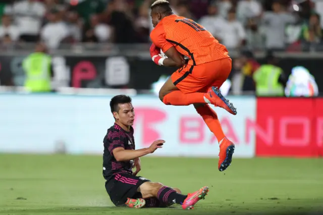 Goalkeeper Chinonso Eziekwe #18 of Nigeria and Hirving Lozano #22 of Mexico fight the ball during the friendly match between Mexico and Nigeria at Los Angeles Memorial Coliseum on July 3, 2021 in Los Angeles, California