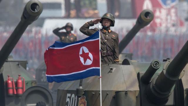 North Korean army tanks conduct a parade