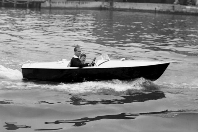 Prince Charles with his father the Duke of Edinburgh in a motor boat