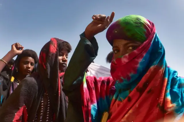 Women dance during the annual Cure Salee festival.