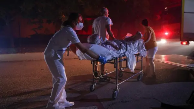 Patients of a chronic diseases management foundation get evacuated as a wildfire burns near Alexandroupoli, in the region of Evros, Greece, August 22, 2023