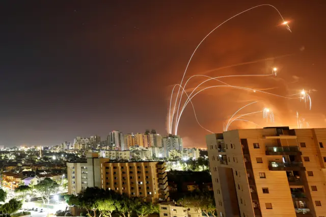 Streaks of light are seen as Israel"s Iron Dome anti-missile system intercept rockets launched from the Gaza Strip towards Israel, as seen from Ashkelon, Israel May 12, 202