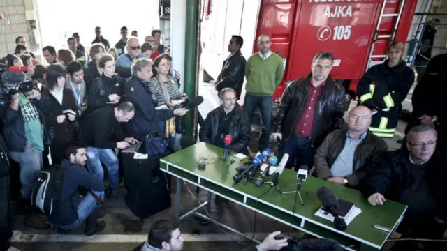 Hungarian Prime Minister Viktor Orban (standing 3R) listens to a journalist's question at the fire station headquarters in Ajka, 140km (87 miles) west of Budapest on 9 October 2010