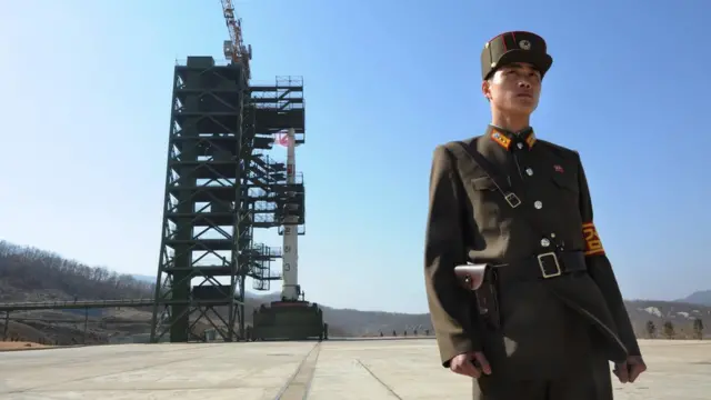 In this file photo taken on April 8, 2012 a North Korean soldier stands guard in front of a Unha-3 rocket at the Sohae Satellite Launch Station in Tongchang-ri.