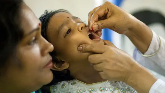 చిన్నపిల్లకు విటమిన్-ఎ క్యాప్సూల్ వేస్తున్న వైద్య సిబ్బంది