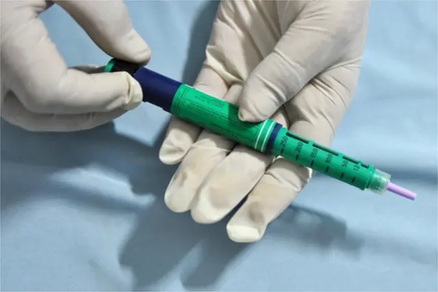 medical assistant holds an insulin pen administered to diabetes patients at a private clinic in New Delhi on November 8, 2011