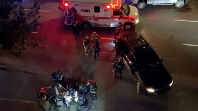 Medics try to save the life of a man who was shot and later died during clashes in Portland, Oregon, 29 August 2020