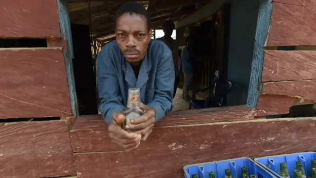 Cameroon refugee dey window dey look