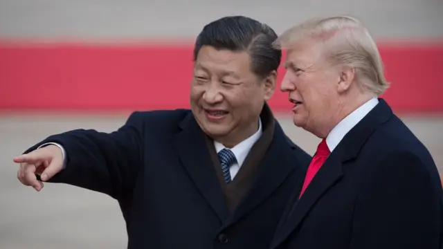 In this file photo taken on November 9, 2017 China"s President Xi Jinping (L) and US President Donald Trump attend a welcome ceremony at the Great Hall of the People in Beijing.
