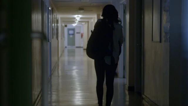 Girl walking in school corridor