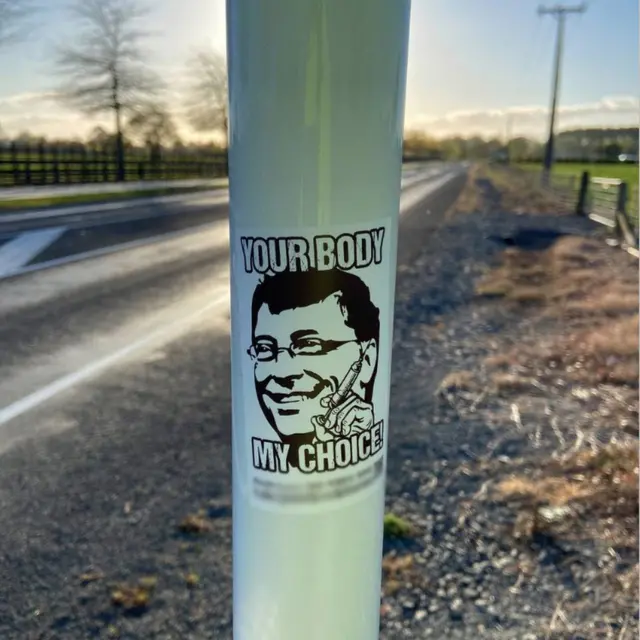 a sticker with Bill Gates head and the slogan "Your body my choice"