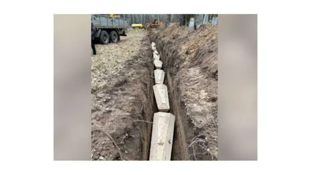 Coffins buried in a trench in Chernihiv