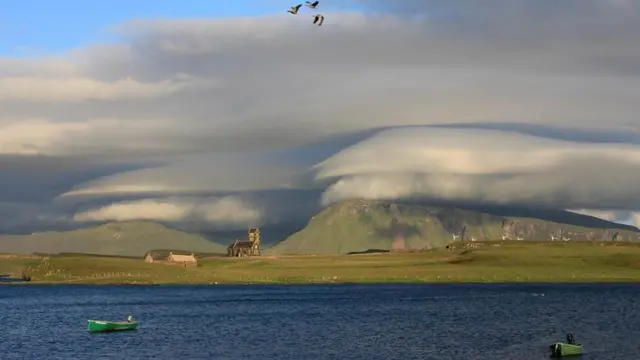 Cloud caps on Rum, photographed from the Isle of Canna, Scottish Inner Hebrides. Photo by Weather Watcher Donald from Canna.