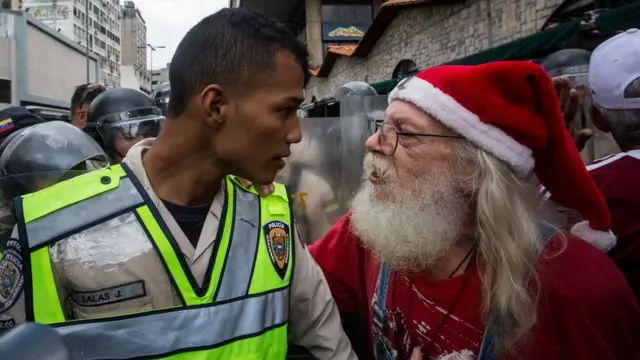 Anciano mira al rostro a uno de los policías que le impedía el paso.