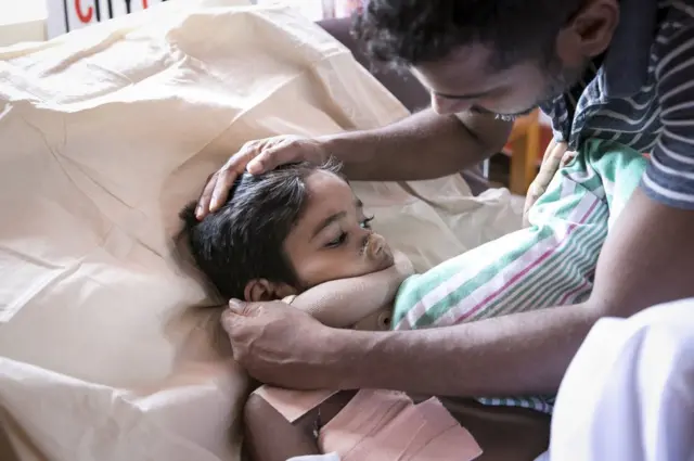 Thashan looks after his son
