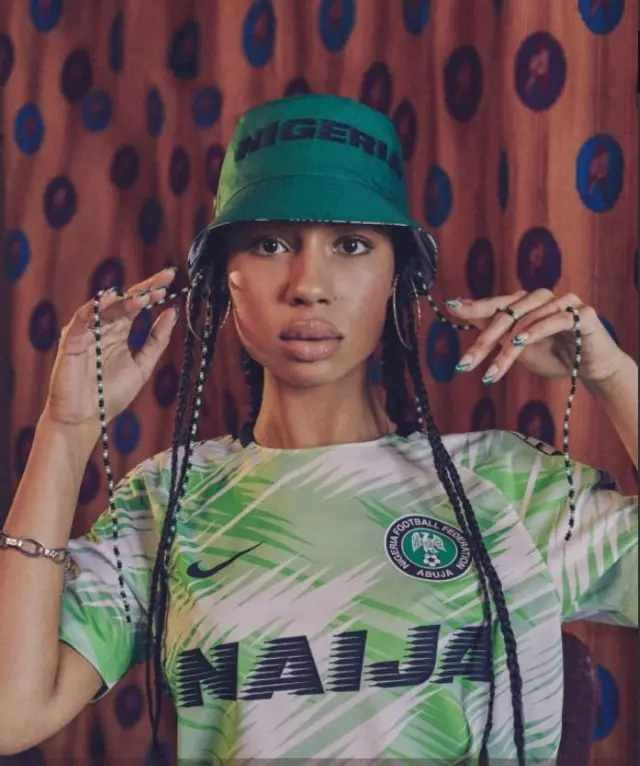Woman wey wear Super Eagles shirt