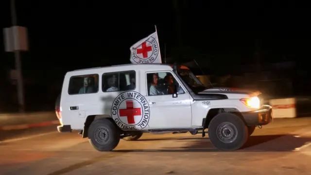 A Red Cross vehicle, as part of a convoy believed to be carrying hostages abducted by Hamas militants during the October 7 attack on Israel, arrives at the Rafah border, amid a hostages-prisoners swap deal between Hamas and Israel, in southern Gaza Strip November 24, 2023.