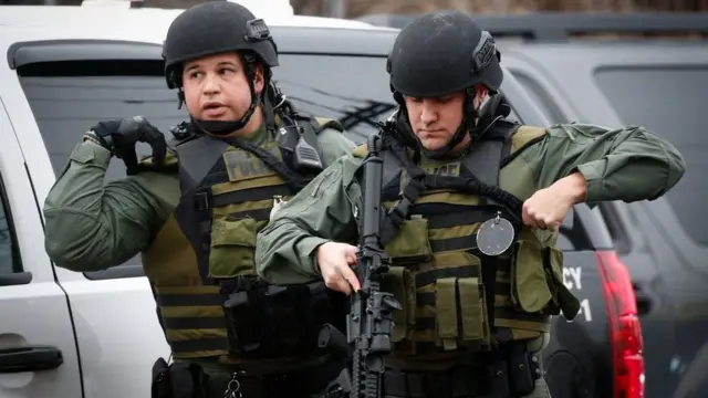 Dozens of armed officers were deployed as the suspects took shelter at a supermarket