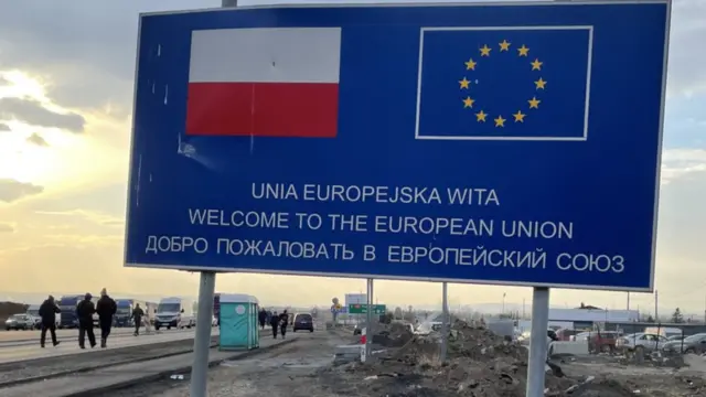A sign at the Polish border with Polish and EU flags