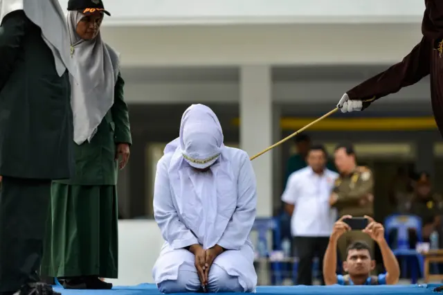 A woman is whipped in public by a member of the Sharia police in Banda Aceh on October 31, 2019, after being caught having an affair with Aceh Ulema Council (MPU) member Mukhlis.