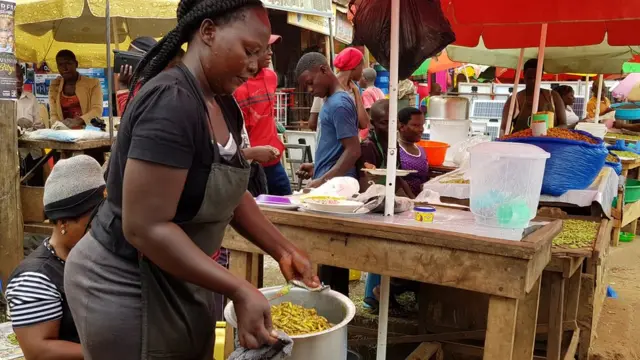 Woman with a pot of grasshoppers