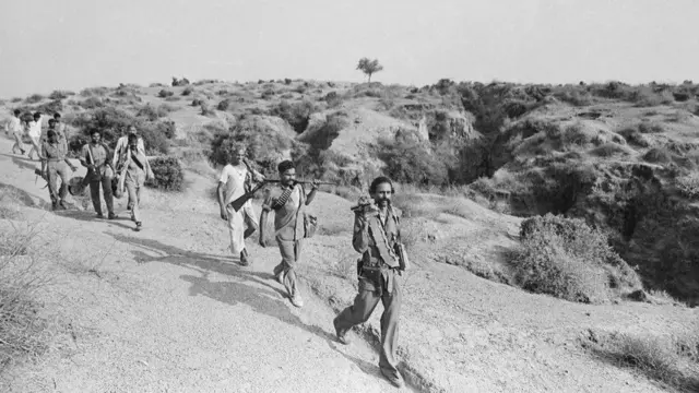 કોતરોમાં એક જગ્યાથી બીજી જગ્યાએ જઈ રહેલી સિંઘ અને તેમની ટુકડી.