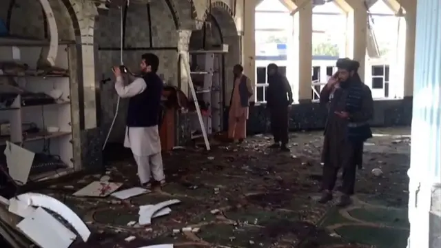 People survey damage to mosque