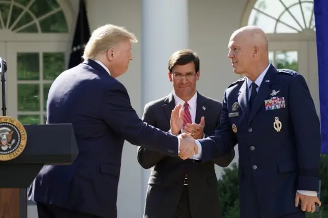 دونالد ترامپ به همراه ژنرال جان ریموند که مسئولیت مرکز فرماندهی جنگ فضایی به او سپرده شده است