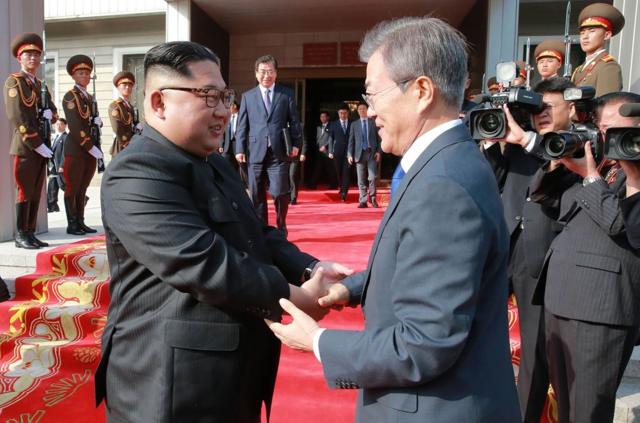This photograph taken on May 26, 2018 and released by North Korea"s official Korean Central News Agency (KCNA) on May 27 shows South Korea"s President Moon Jae-in (R) shaking hands with North Korea"s leader Kim Jong Un after their second summit at the north side of the truce village of Panmunjom in the Demilitarized Zone (DMZ). Kim Jong Un believes a summit with US President Donald Trump will be a landmark opportunity to end decades of confrontation, South Korea"s President Moon Jae-in said May 27 following his surprise meeting with the North Korean leader. / AFP PHOTO / KCNA VIA KNS /