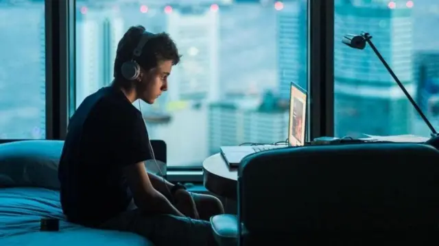 صبي يستخدم جهاز كمبيوتر