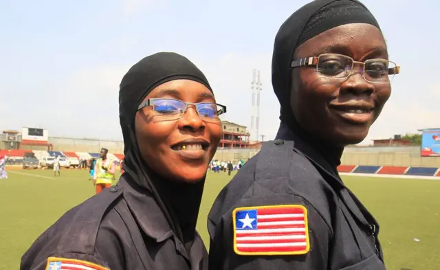 Two female police officers in hijabs at a stadium in Monrovia, Liberia - Wednesday 1 February 2017