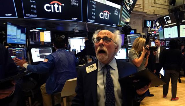 Trader Peter Tuchman reacts as he works on the floor during the opening bell on the New York Stock Exchange on Monday. Trading on Wall Street was temporarily halted as US stocks joined a global rout on crashing oil prices and mounting worries over the coronavirus outbreak. 9 March 2020