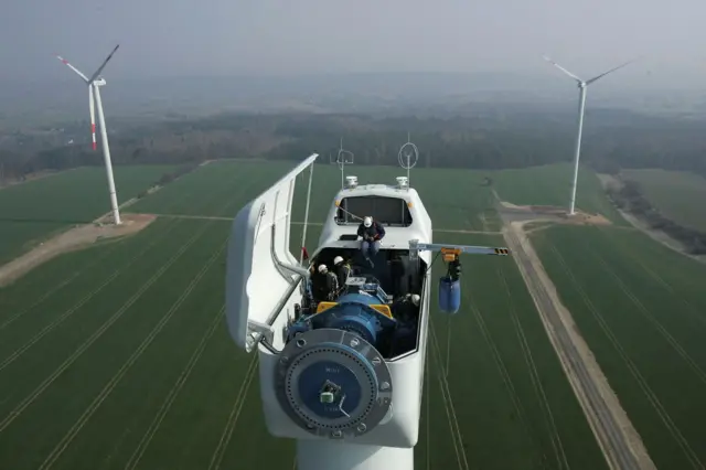Trabajadores en lo alto de una turbina eólica